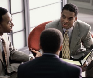 Three businessmen talking in a meeting
